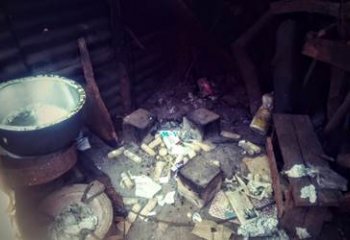 Household using paper as tinder and maize cobs as fuel on 3 Stone Cook Stove